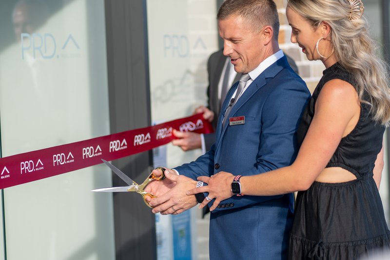 PRD Port Stephens Principal Dane Queenan and Carla Queenan cutting grand opening ribbon